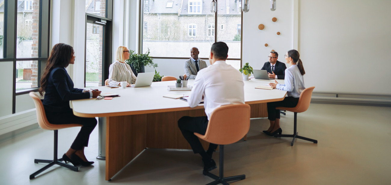 Employees meeting around conference table